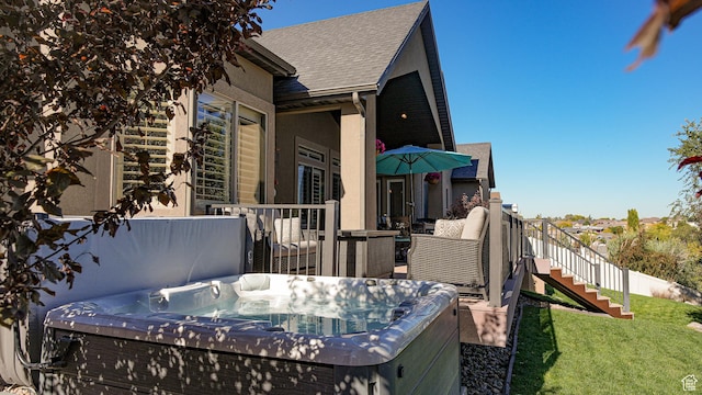 view of home's exterior with a yard and a hot tub