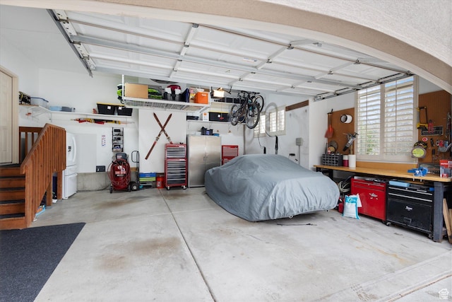 garage featuring a workshop area and stainless steel refrigerator