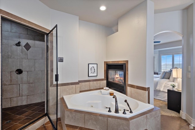 bathroom featuring tile patterned floors, separate shower and tub, and a fireplace