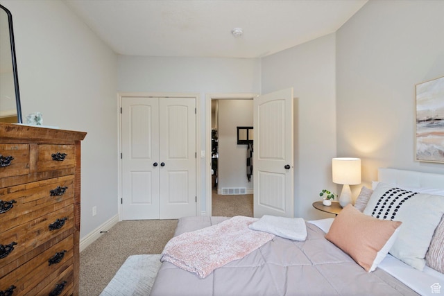 bedroom with light carpet and a closet