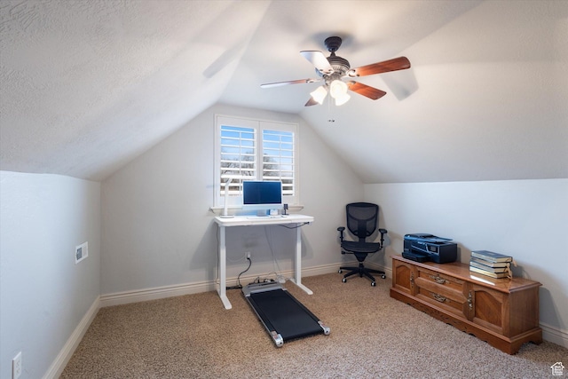 office featuring a textured ceiling, ceiling fan, light carpet, and vaulted ceiling