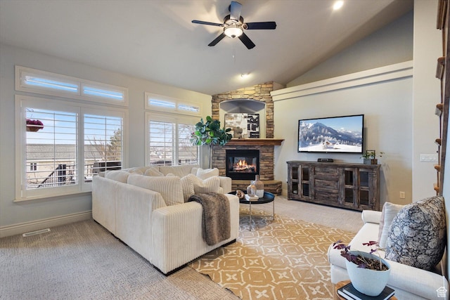 carpeted living room featuring ceiling fan, a fireplace, and vaulted ceiling