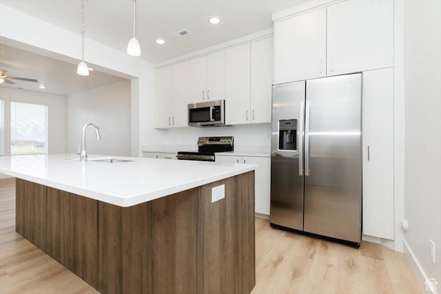 83 E 750 S Unit 05, Springville, UT 84663 - kitchen featuring appliances with stainless steel finishes, a sink, light wood-style floors, white cabinetry, and light countertops