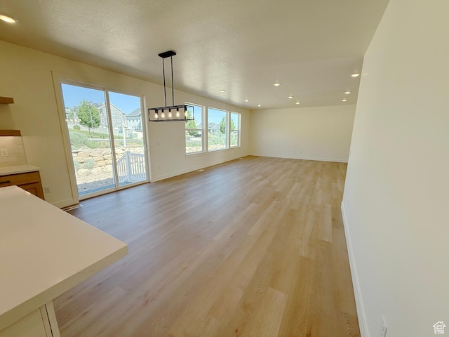 3241 S Red Wolf Dr, Saratoga Springs, UT 84045 - unfurnished dining area featuring light wood finished floors, baseboards, recessed lighting, and a chandelier