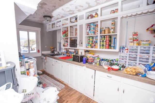 128 N 8th St, Montpelier, ID 83254 - kitchen with white cabinets, a sink, open shelves, and light wood-style floors