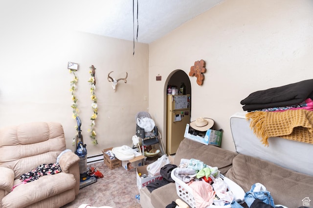 128 N 8th St, Montpelier, ID 83254 - living area featuring a baseboard radiator, arched walkways, and carpet