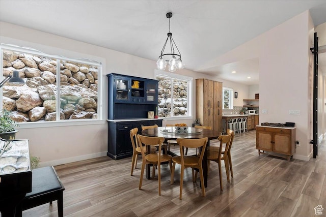 13802 S Mount Shaggy Dr, Herriman, UT 84096 - dining space featuring an inviting chandelier, vaulted ceiling, and hardwood / wood-style flooring