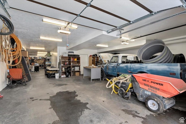 13802 S Mount Shaggy Dr, Herriman, UT 84096 - garage with a workshop area and a garage door opener