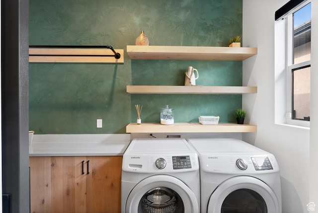 clothes washing area with washing machine and clothes dryer