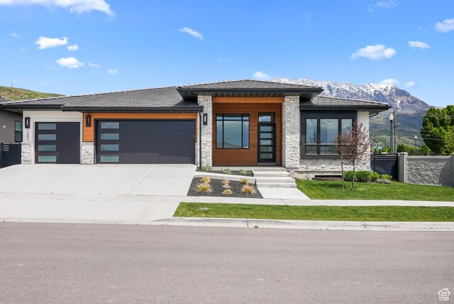 1302 N 750 E, Orem, UT 84097 - view of front of house with a garage, stone siding, concrete driveway, and a mountain view