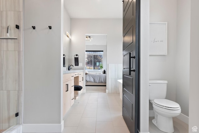 bathroom featuring tile patterned flooring, vanity, and toilet