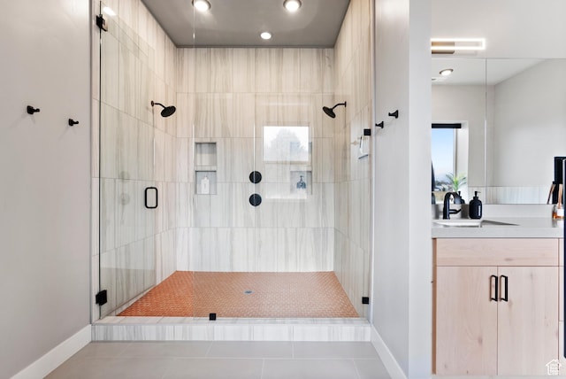 bathroom featuring tile patterned floors, vanity, and a shower with shower door