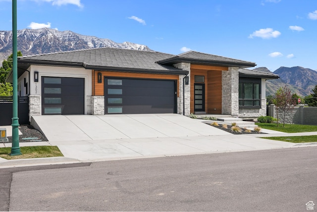 1302 N 750 E, Orem, UT 84097 - view of front facade with stone siding, an attached garage, a mountain view, and driveway