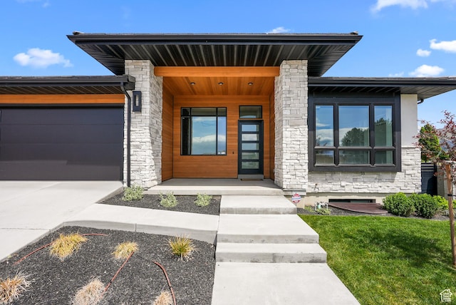 1302 N 750 E, Orem, UT 84097 - view of front facade with stone siding, a garage, and driveway