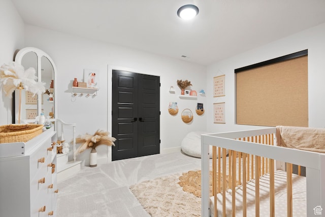 bedroom with carpet and a crib
