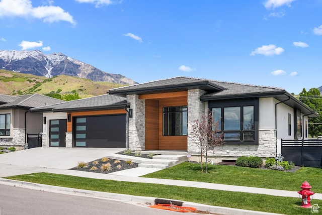 1302 N 750 E, Orem, UT 84097 - prairie-style home featuring stone siding, a garage, driveway, and a mountain view