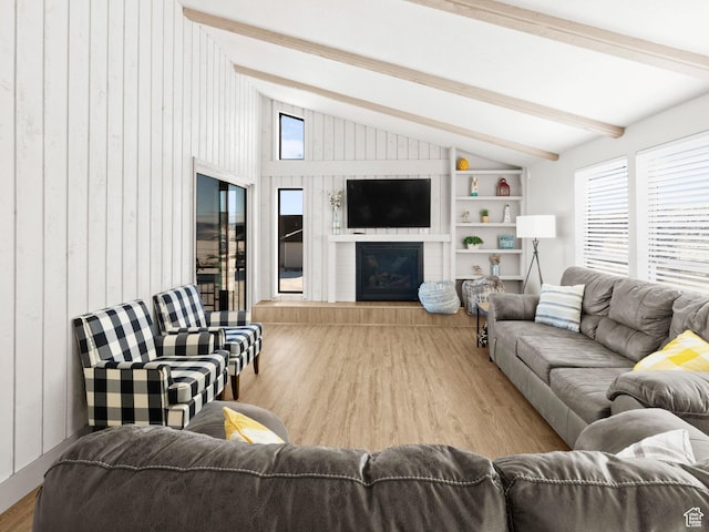 3092 S Country Club Way, Garden City, UT 84028 - living area featuring plenty of natural light, built in shelves, vaulted ceiling with beams, and wood finished floors