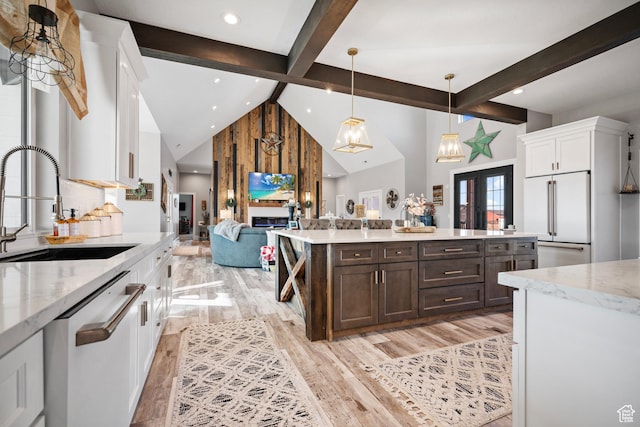 kitchen featuring sink, hanging light fixtures, light stone counters, white appliances, and white cabinets