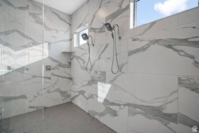 interior details featuring tiled shower