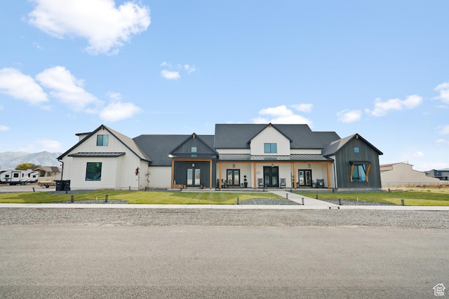 modern farmhouse style home with a front lawn