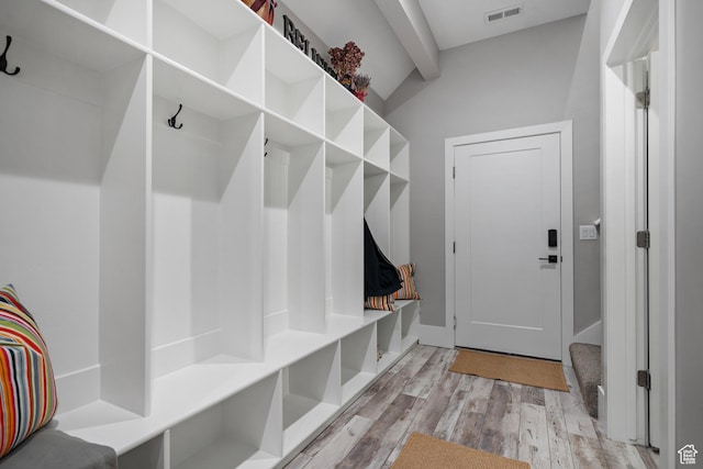 mudroom featuring lofted ceiling with beams and light hardwood / wood-style floors