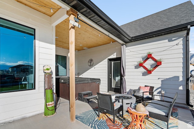 view of patio featuring an outdoor fire pit and a hot tub