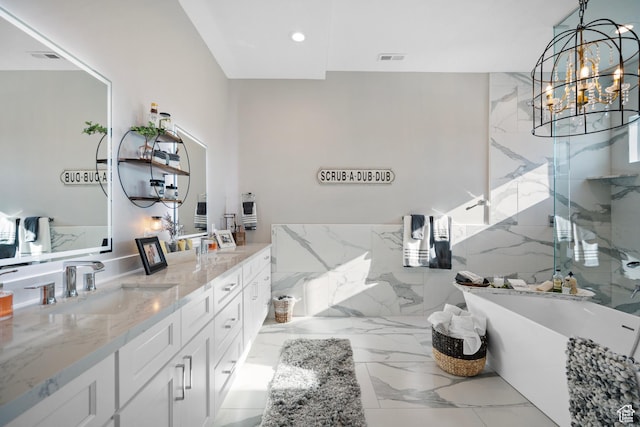 bathroom with vanity, independent shower and bath, and a chandelier