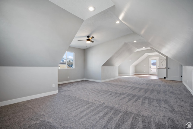 additional living space with carpet flooring, ceiling fan, lofted ceiling, and a textured ceiling