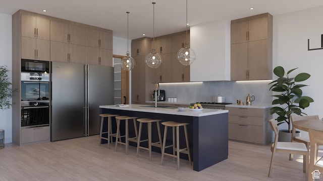 2114 S Pinto St Unit 76, Washington, UT 84780 - kitchen with tasteful backsplash, a center island with sink, light hardwood / wood-style flooring, stainless steel refrigerator, and hanging light fixtures