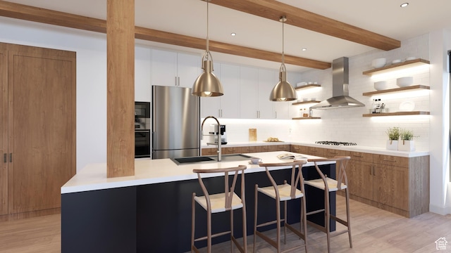 2114 S Pinto St Unit 76, Washington, UT 84780 - kitchen with white cabinetry, stainless steel appliances, tasteful backsplash, light hardwood / wood-style floors, and island range hood