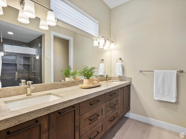 bathroom with tile patterned flooring, double vanity, baseboards, a sink, and a stall shower