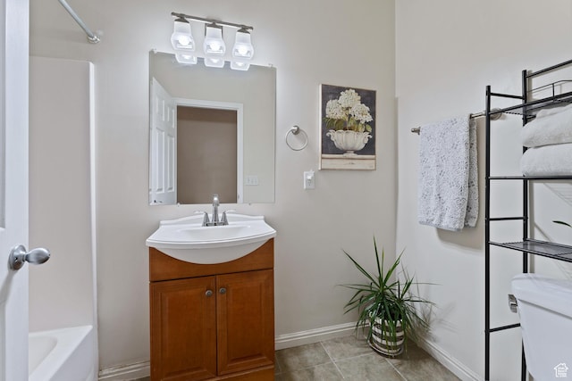 7112 N Mohican Dr E, Eagle Mountain, UT 84005 - full bathroom featuring tile patterned flooring, vanity, toilet, and washtub / shower combination
