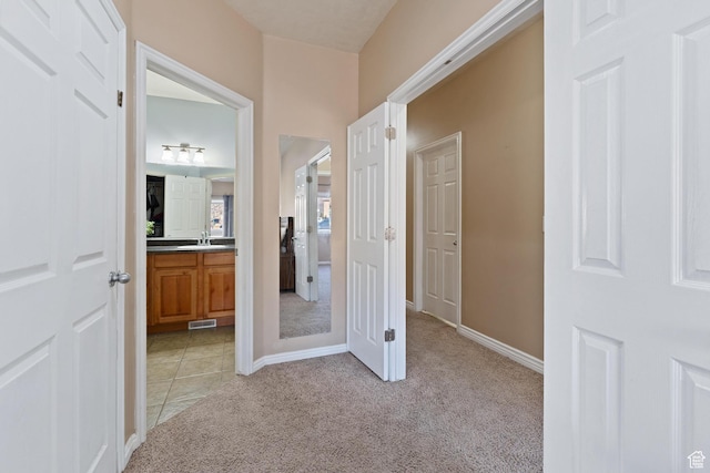 7112 N Mohican Dr E, Eagle Mountain, UT 84005 - corridor featuring light carpet and sink