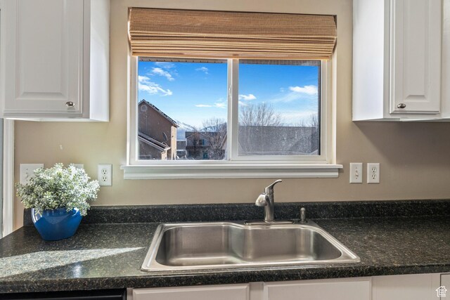 7112 N Mohican Dr E, Eagle Mountain, UT 84005 - room details with dishwashing machine, white cabinetry, and sink