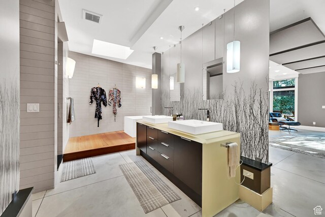 1762 E Millcreek Way, Millcreek, UT 84106 - bathroom featuring a skylight, concrete floors, double vanity, and recessed lighting