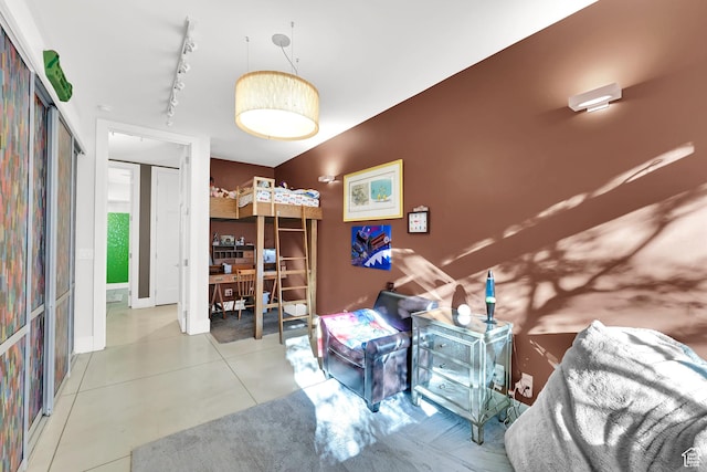 1762 E Millcreek Way, Millcreek, UT 84106 - bedroom featuring rail lighting, tile patterned flooring, and baseboards