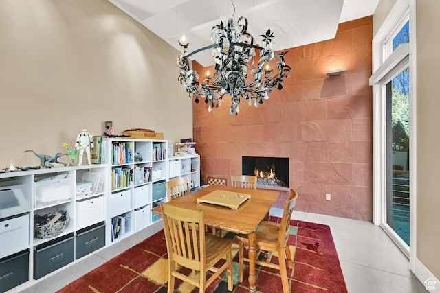 1762 E Millcreek Way, Millcreek, UT 84106 - dining space with a chandelier, tile walls, and a lit fireplace