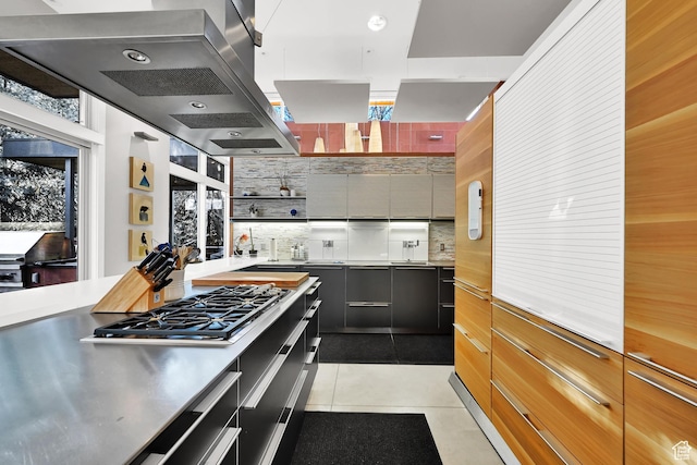 1762 E Millcreek Way, Millcreek, UT 84106 - kitchen featuring stainless steel countertops, stainless steel gas stovetop, modern cabinets, tasteful backsplash, and light tile patterned floors