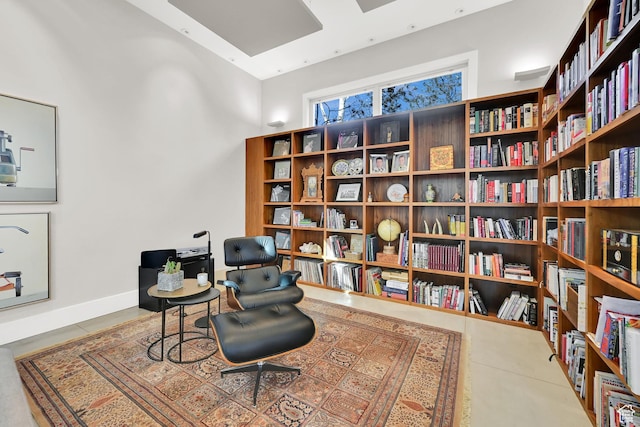 1762 E Millcreek Way, Millcreek, UT 84106 - living area with tile patterned floors, wall of books, and a towering ceiling