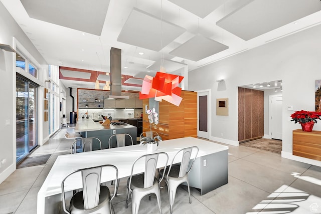 1762 E Millcreek Way, Millcreek, UT 84106 - kitchen with coffered ceiling, backsplash, island exhaust hood, a breakfast bar, and baseboards