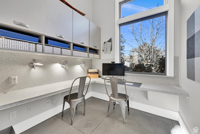 1762 E Millcreek Way, Millcreek, UT 84106 - home office featuring finished concrete flooring, built in desk, and baseboards