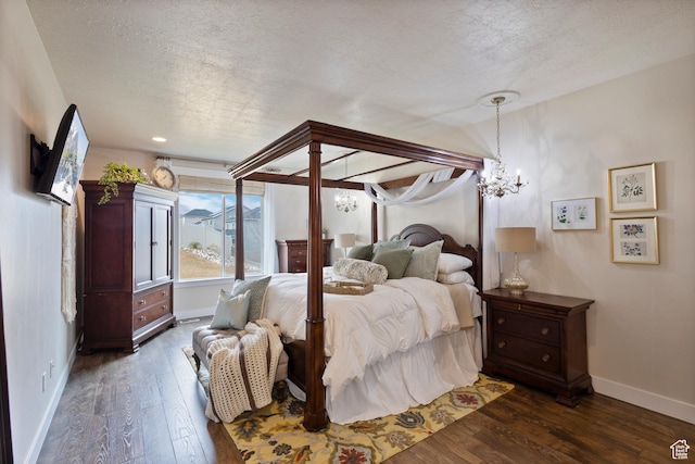 536 W Granite Cir, Saratoga Springs, UT 84045 - bedroom featuring baseboards, a notable chandelier, a textured ceiling, and dark wood-type flooring
