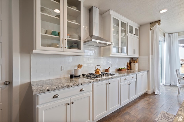 536 W Granite Cir, Saratoga Springs, UT 84045 - kitchen featuring wall chimney range hood, white cabinets, stainless steel gas cooktop, a textured ceiling, and dark wood-type flooring
