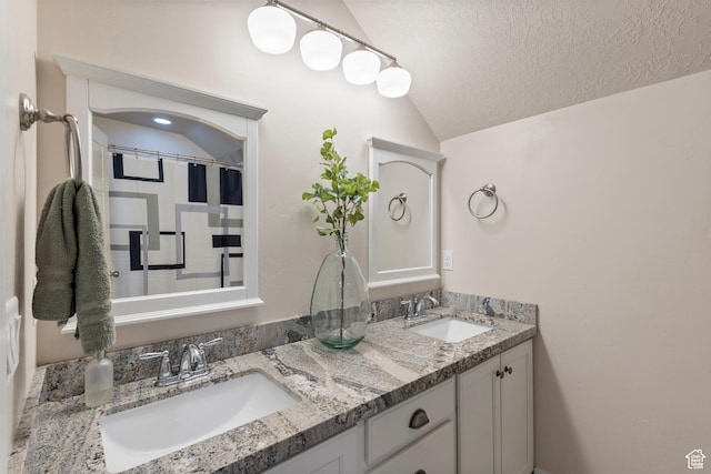 536 W Granite Cir, Saratoga Springs, UT 84045 - bathroom with double vanity, a sink, a textured ceiling, and vaulted ceiling