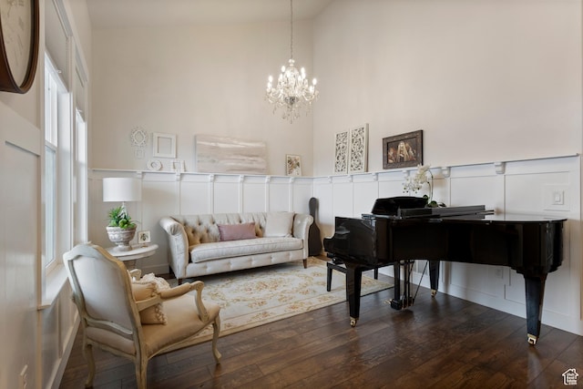 536 W Granite Cir, Saratoga Springs, UT 84045 - sitting room with plenty of natural light, a towering ceiling, a notable chandelier, and hardwood / wood-style floors