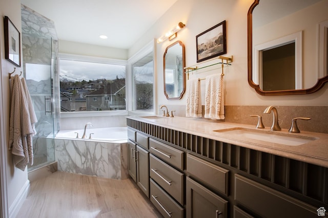 2783 S Irene Dr E, Bountiful, UT 84010 - bathroom featuring double vanity, a sink, wood finished floors, and a bath