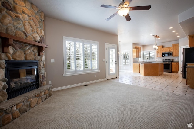 2783 S Irene Dr E, Bountiful, UT 84010 - living room with light carpet, a wealth of natural light, ceiling fan, and light tile patterned floors