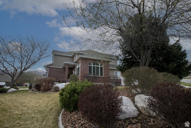 2783 S Irene Dr E, Bountiful, UT 84010 - view of side of property with a lawn, stucco siding, and brick siding