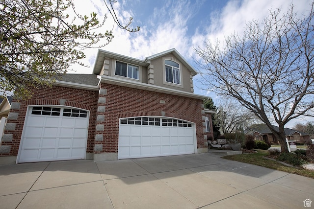 2783 S Irene Dr E, Bountiful, UT 84010 - view of front of house featuring brick siding, a garage, concrete driveway, and a shingled roof