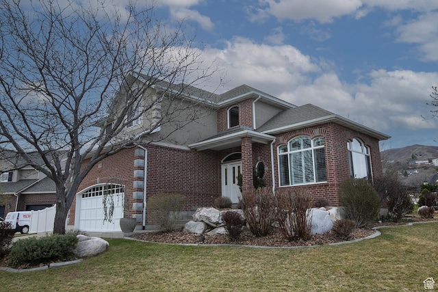 traditional-style house with brick siding, a shingled roof, and a front yard